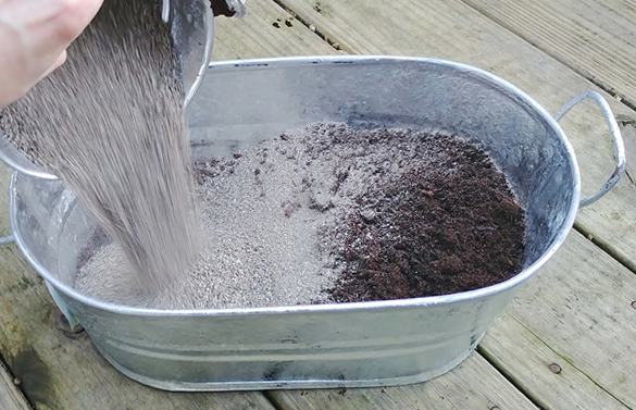 mixing potting soil in galvanized tub